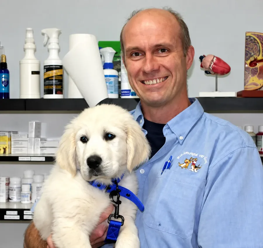Dr John Houghton holding a puppy